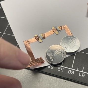 I added an extension to the copper tape to make it reach both batteries. The connection was really poor so when the lights were on they were barely on.