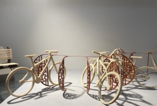 a set of plastic bicycles in a bicycle rack found in front of the ceramic sudio. This is modeled by the students in the industrial design program and this material is used by the Industrial design program.