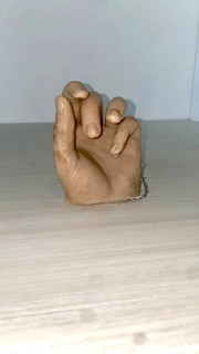 This is an object made of multiple refined materials. it is made of a wire structure that is a refined metal of some sort encased in a rubbery silicone like hand. The hand is very pliable amd flexible. you can squish, move and pull the hand. It will return to it's molded state unless a section is torn. Thes materials are used for a wide variety of things. silicone is great for making pliable molds and wire is invredibly versitile. it can be used to make sculpture, to make tools, wire is also even used in some clothing. 